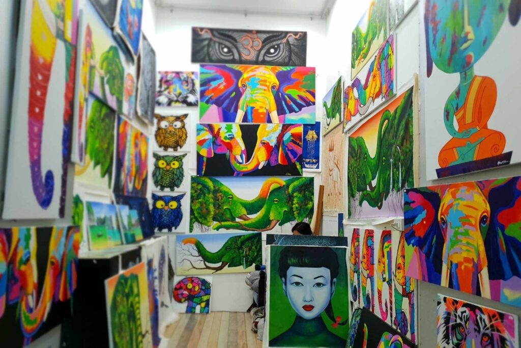 Colourful art depicting Elephants and other animals local to Thailand for sale at Naka Night Market, Phuket