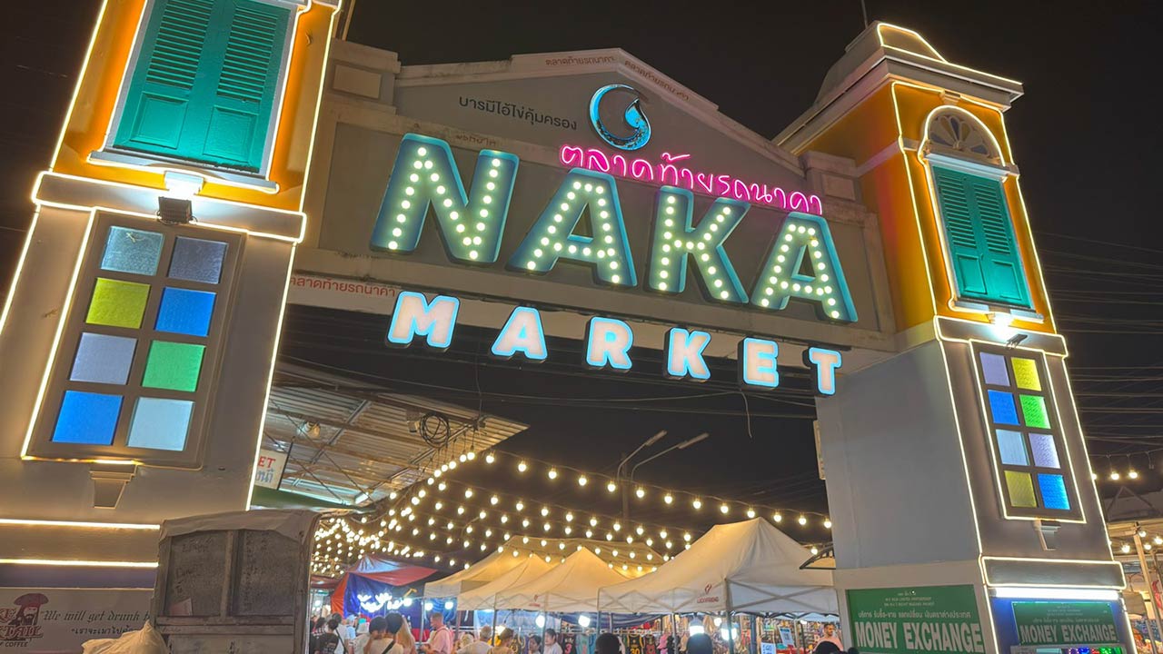 Take a picture of the neon sign at Naka Weekend Market